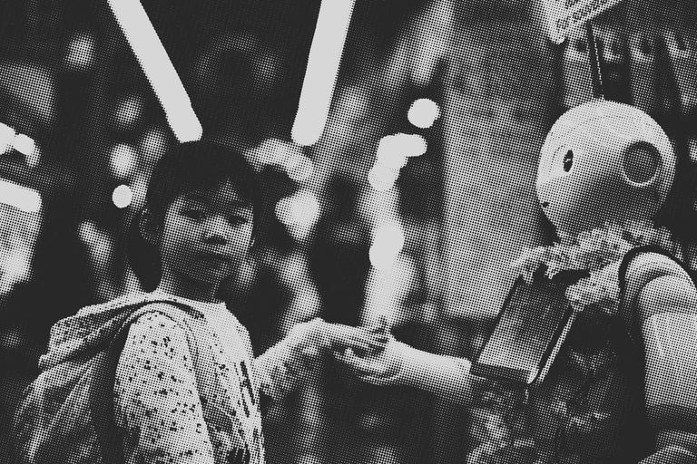 Girl holding the hand of a robot